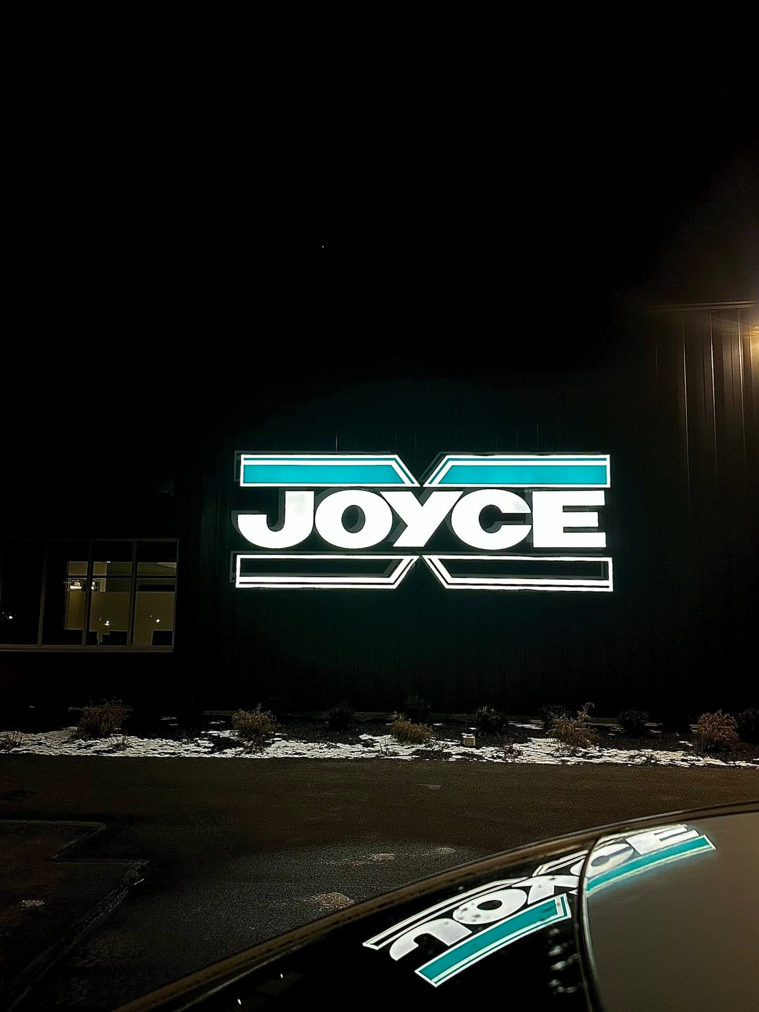 Illuminated sign by Display Craft Signs at night